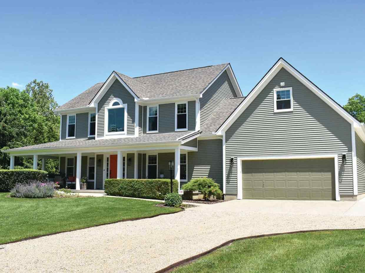 Two-story gray home with white trim, large front porch, and vinyl siding and windows
