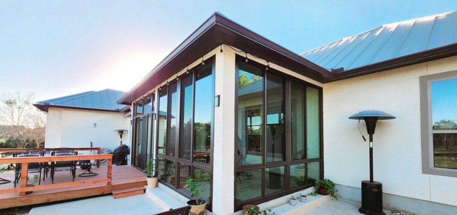 Contemporary San Antonio patio enclosure with sleek black-framed glass—perfect for expanding usable space in warm climates with style and efficiency.