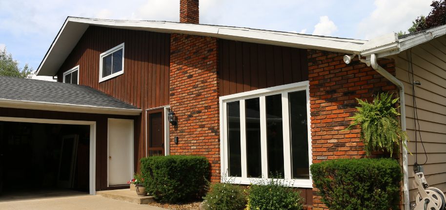 Charming brick and wood home with updated windows, featuring Great Day Improvements’ exterior renovation services in Arvada, Colorado.