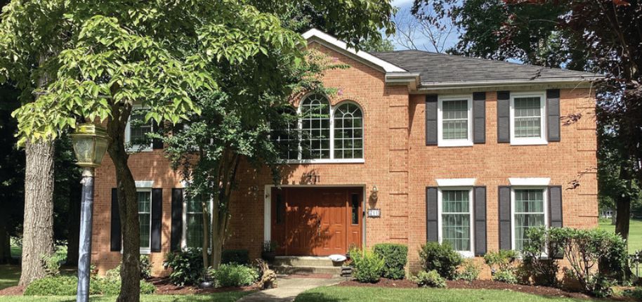 Traditional brick home with large front windows and detailed trim, showcasing Great Day Improvements’ professional home renovation services in Beachwood, Ohio.