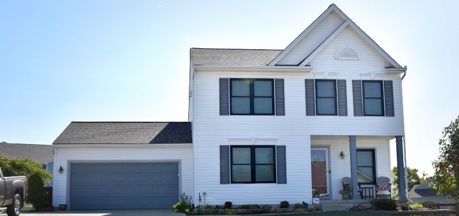 Great Day Improvements completed this elegant home renovation in Caledonia, featuring new siding, trim, and updated windows.