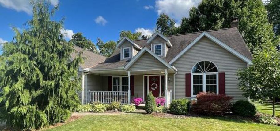 Cape Cod-inspired home in Columbia with dormer windows and maroon accents—perfectly blending style, function, and southern living values.