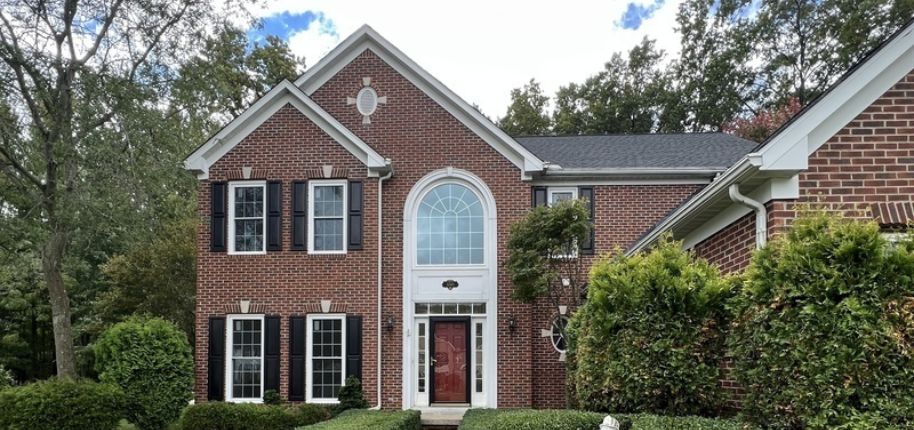 Beautiful red two-story home demonstrating Great Day Improvements’ expert home remodeling available to homeowners throughout Dyer.
