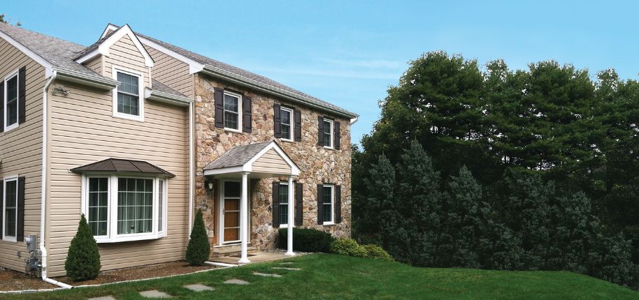 Elegant two-story home surrounded by lush greenery, remodeled by Great Day Improvements in Huntersville, North Carolina.