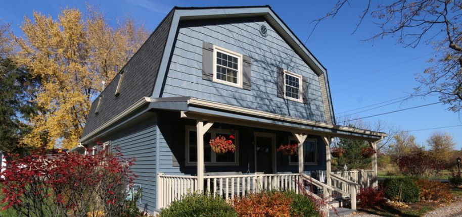 Charming blue farmhouse-style home highlighting Great Day Improvements’ quality home remodeling work in Louisville, Nebraska.