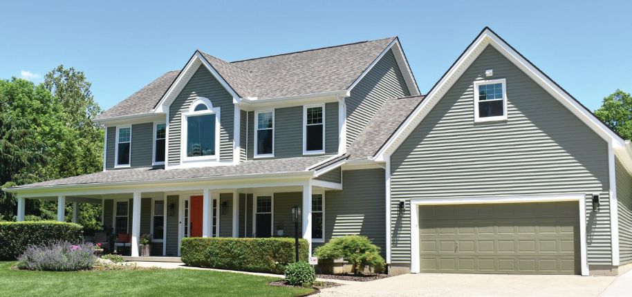 Elegant stone and stucco home with dark trim and three-car garage, highlighting Great Day Improvements’ high-quality home renovation in Mentor, Ohio.