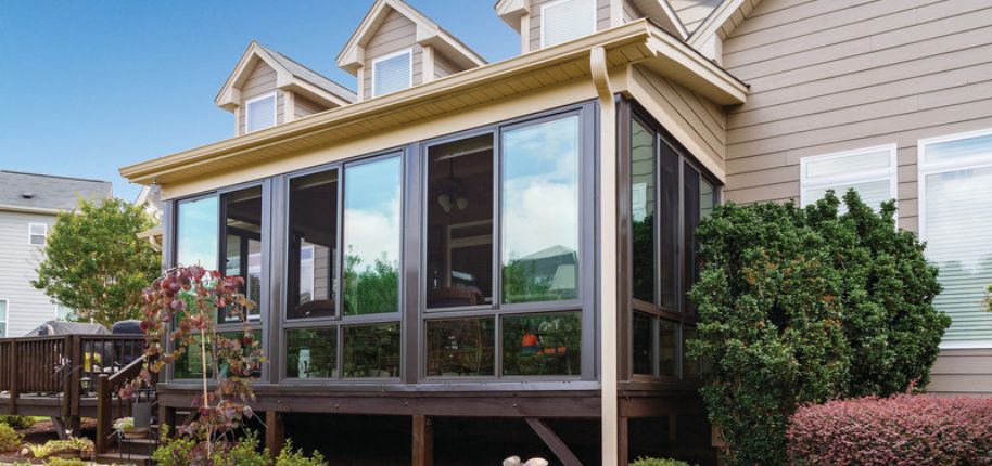 Raleigh home with custom-built sunroom addition featuring floor-to-ceiling windows—designed for year-round enjoyment and functional indoor-outdoor living.