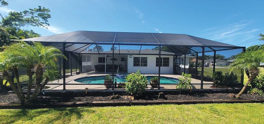 Bright and breezy screened lanai in Seffner, Florida, with a modern finish and minimalist landscaping—built by Great Day Improvements for stress-free outdoor enjoyment.