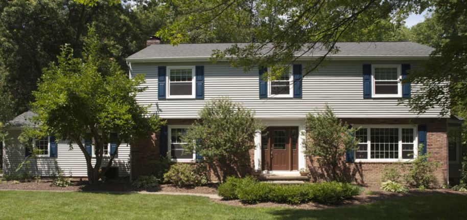 Traditional two-story home in St. Louis with symmetrical windows and a brick façade—built for lasting comfort and ideal for whole-home exterior upgrades.