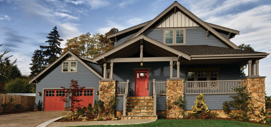 Beautiful two-story red home demonstrating Great Day Improvements’ expert home remodeling available to homeowners near Walton.