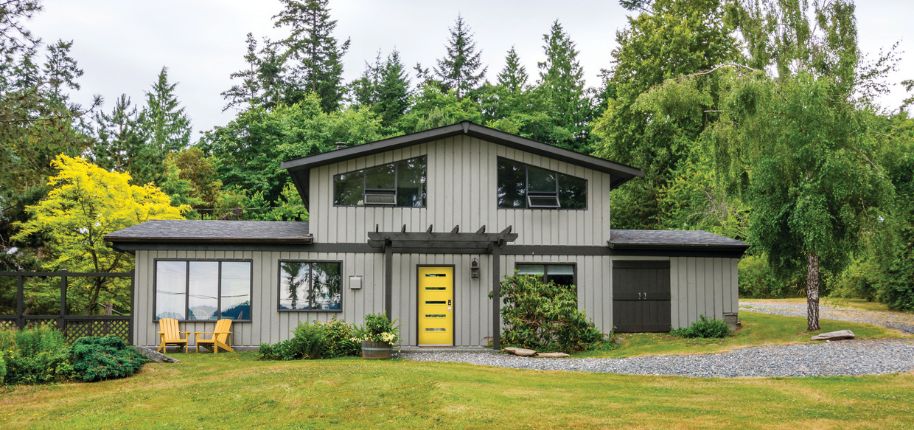 Charming two-story home with gray siding and a yellow front door, highlighting Great Day Improvements’ professional remodeling in Wheat Ridge, Colorado.