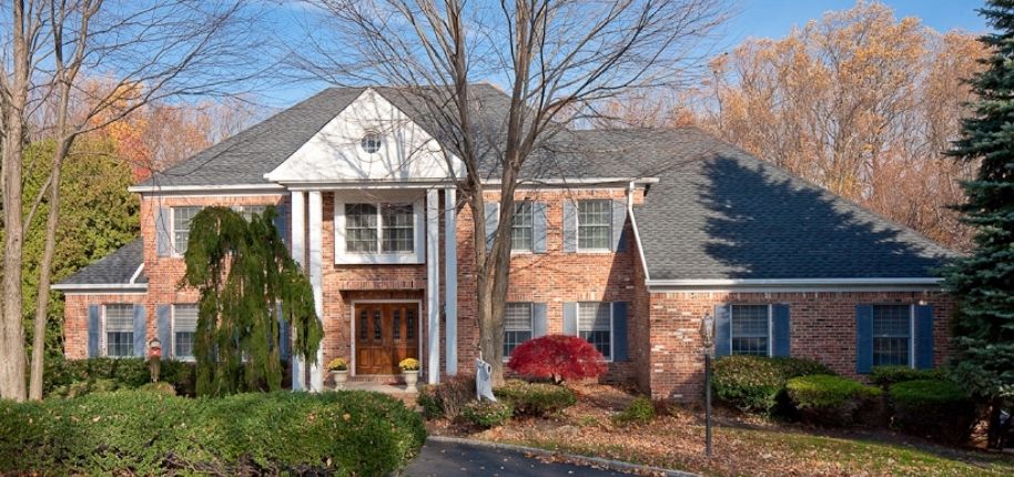 Front exterior renovation by Great Day Improvements featuring updated windows and a refreshed brick façade that enhances curb appeal and long-term value,