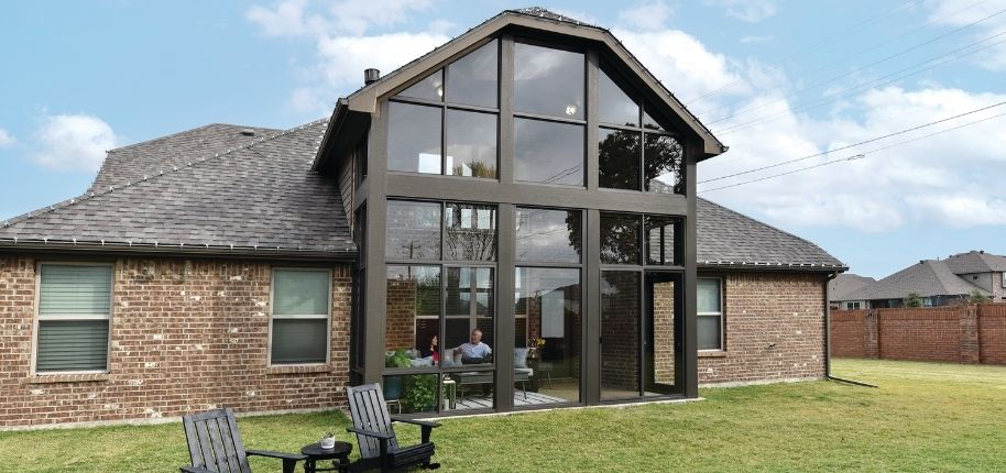 Luxury sunroom addition by Great Day Improvements overlooking a backyard pool, designed to maximize natural light and year-round enjoyment