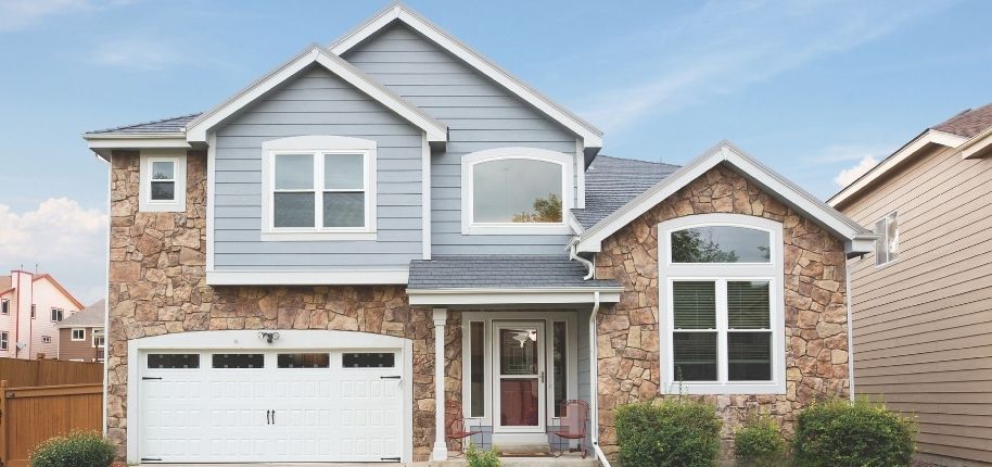 Front exterior improvement by Great Day Improvements with updated windows, shutters, and entry details for a polished traditional look.