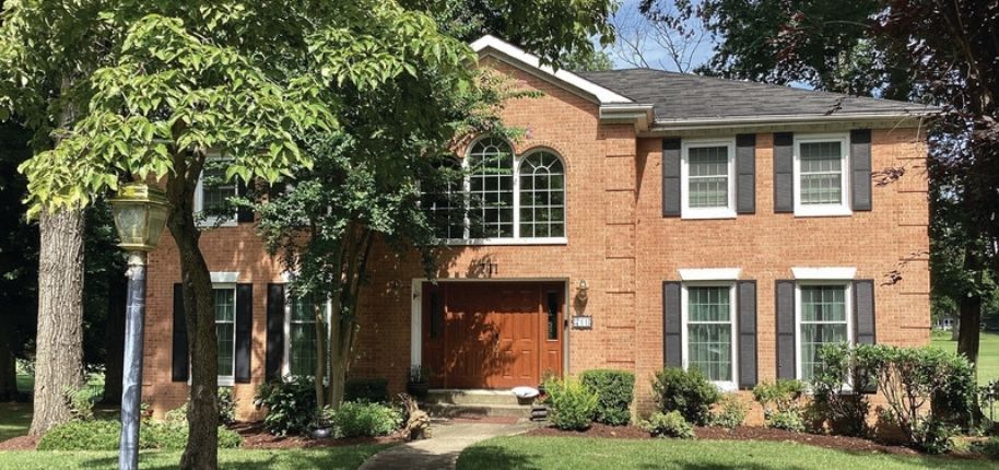 Traditional brick home with updated windows and refreshed exterior details, remodeled by Great Day Improvements to improve comfort, performance, and timeless curb appeal.
