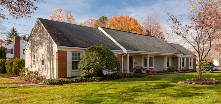 Single-story home with updated siding, roofing, and energy-efficient windows, remodeled by Great Day Improvements to refresh curb appeal and improve comfort and durability.
