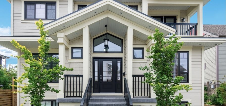 Craftsman-style home with covered entry, updated siding, black-framed windows, and modern front doors, remodeled by Great Day Improvements to create a welcoming, high-impact first impression.