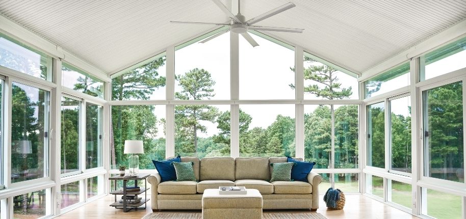 Interior sunroom with vaulted ceilings, floor-to-ceiling windows, and panoramic outdoor views, remodeled by Great Day Improvements to create a bright, relaxing living space.