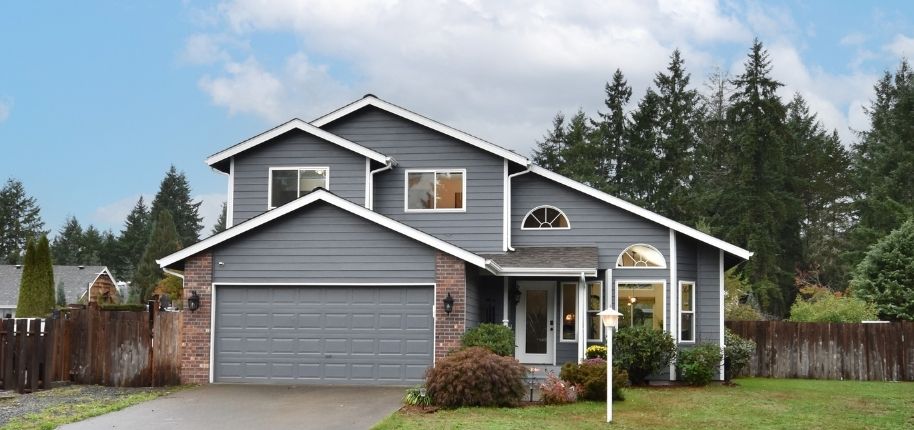 Modern gray home with refreshed exterior siding, replacement windows, and updated entry details, remodeled by Great Day Improvements to improve performance and contemporary style.