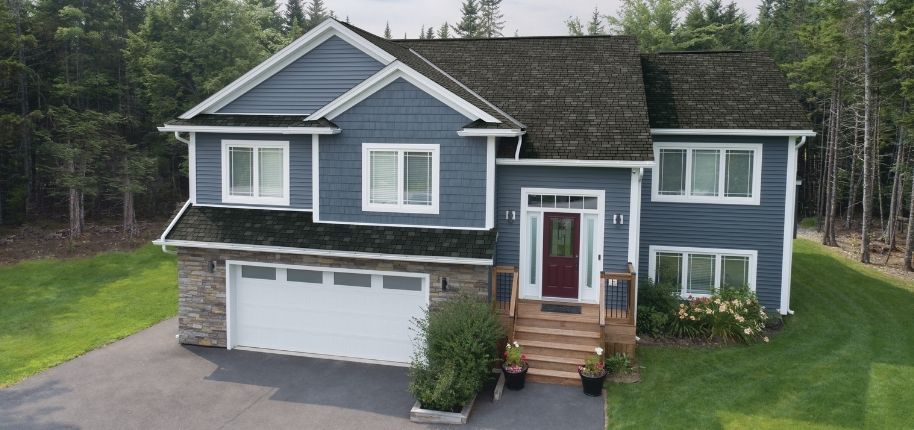 Two-story home with refreshed siding, stone accents, and an updated front entry, remodeled by Great Day Improvements to boost curb appeal and long-term value.