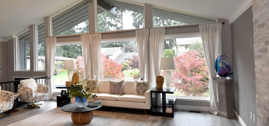 Contemporary living room with expansive picture windows and scenic neighborhood views, renovated by Great Day Improvements to maximize natural light and energy efficiency.
