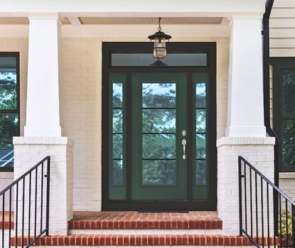 Great Day Improvements completed this stylish front door installation, featuring a green double door and sidelights for added curb appeal.
