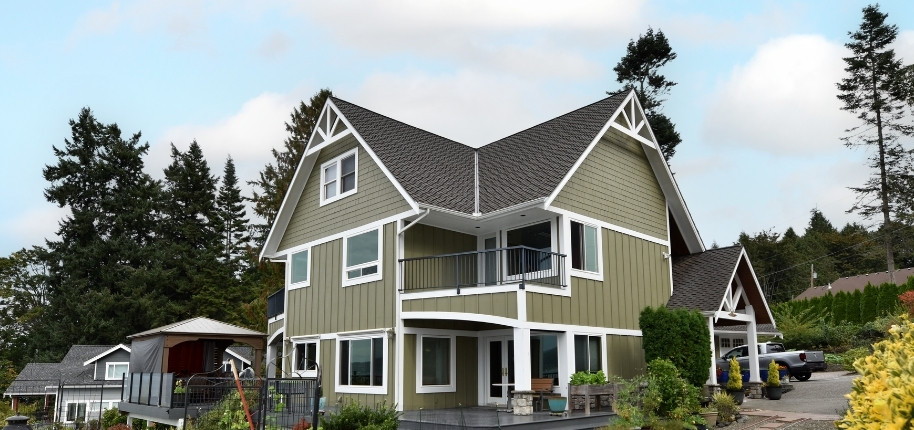 Two-story craftsman-style home with new siding, trim, and energy-efficient windows, renovated by Great Day Improvements to deliver bold curb appeal.