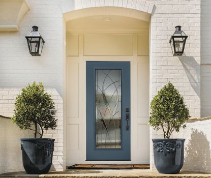 This modern blue entry door with decorative glass was expertly installed by Great Day Improvements as part of an energy-efficient front door replacement.