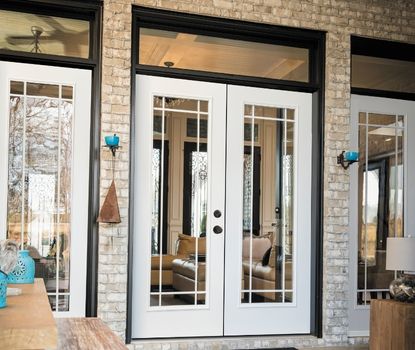 These elegant glass French doors with decorative grids were installed by Great Day Improvements as part of a premium patio door replacement.