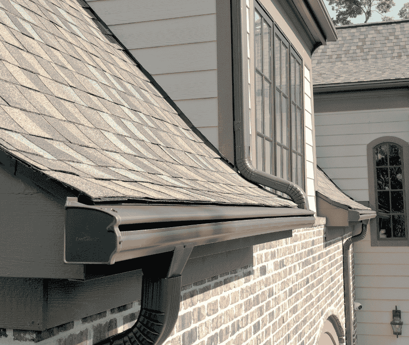 Brown Leafguard system expertly installed on a brown brick home.