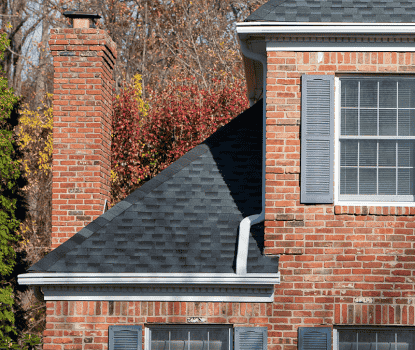 White Leafguard gutter system on a home with multiple roof levels.
