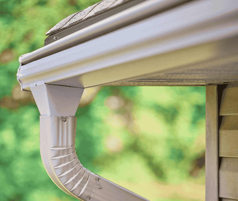 White Leafguard gutter system with a downspout.