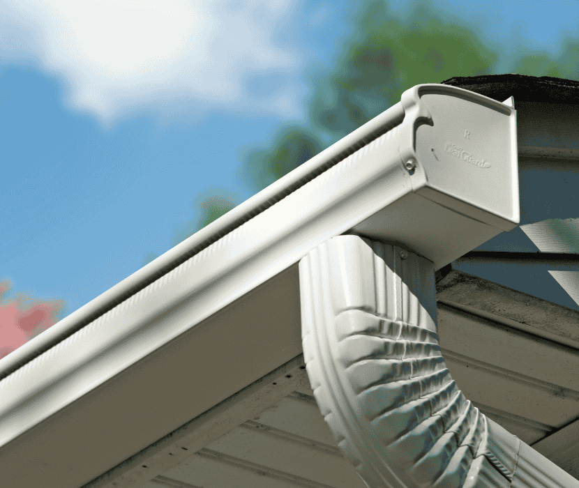 White Leafguard gutter system under a blue sky.