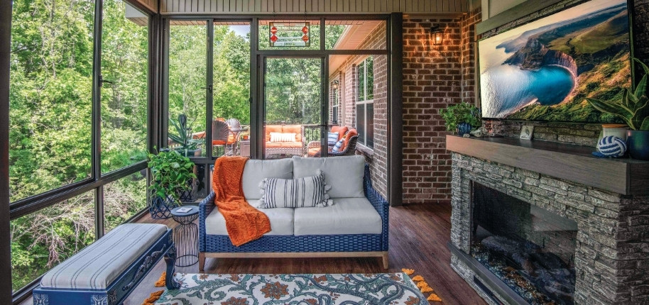 Screened porch with fireplace and outdoor entertainment area, renovated by Great Day Improvements for comfortable, all-season relaxation.
