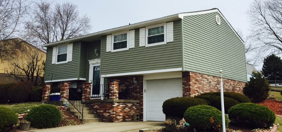 Split-level home with new vinyl siding and upgraded windows, renovated by Great Day Improvements to boost energy efficiency and long-term protection.