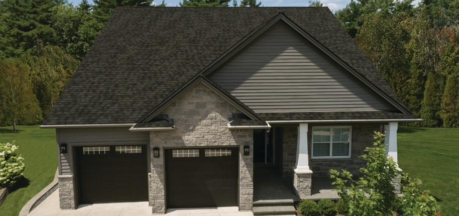 Stone and siding home with upgraded architectural shingle roof and enhanced exterior protection, renovated by Great Day Improvements for strength and style.