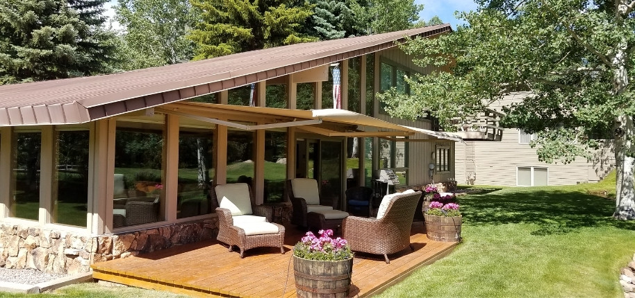 Mid-century style home with expansive windows and extended deck addition, renovated by Great Day Improvements to blend indoor comfort with outdoor living.