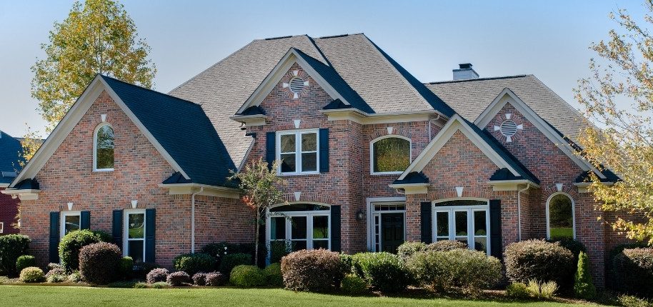 A large, multi-story brick home.