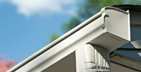 Close up shot of a Leafguard gutter underneath a blue sky on a sunny day.
