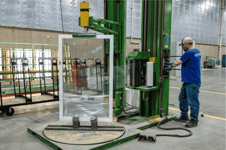 A worker prepares a patio door for shipment out of Great Day Improvement's manufacturing facility in Walton Hills, OH.